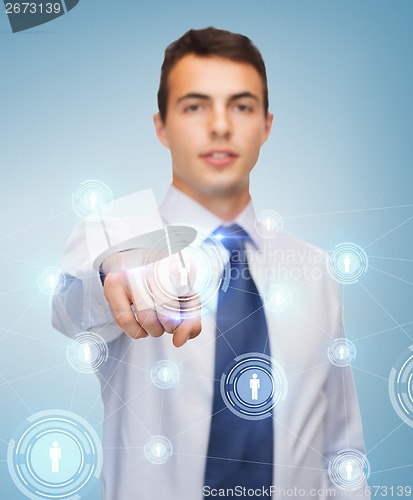 Image of buisnessman pointing finger to virtual screen
