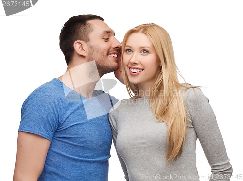 Image of smiling boyfriend telling girlfriend secret