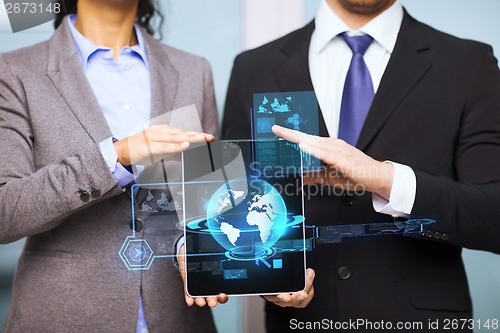 Image of businessman and businesswoman with tablet pc