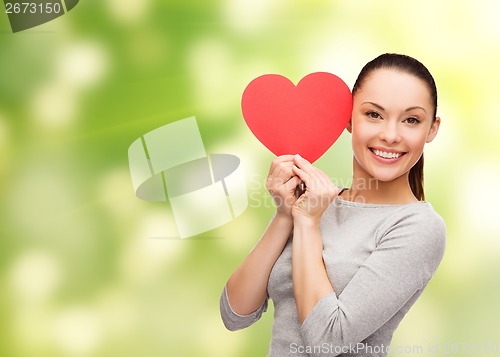 Image of smiling asian woman with red heart