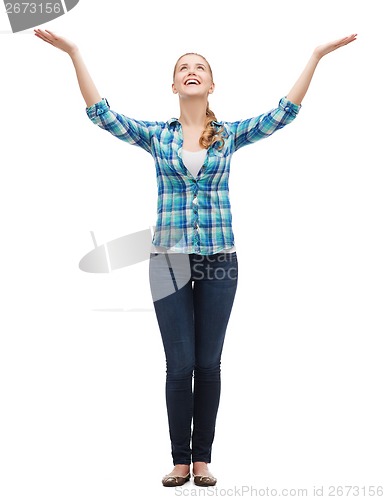 Image of smiling young woman waving hands