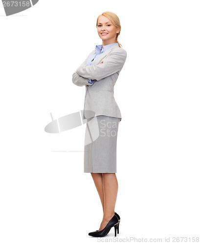 Image of smiling businesswoman with crossed arms