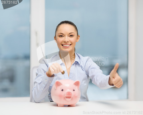 Image of smiling woman with piggy bank and cash money