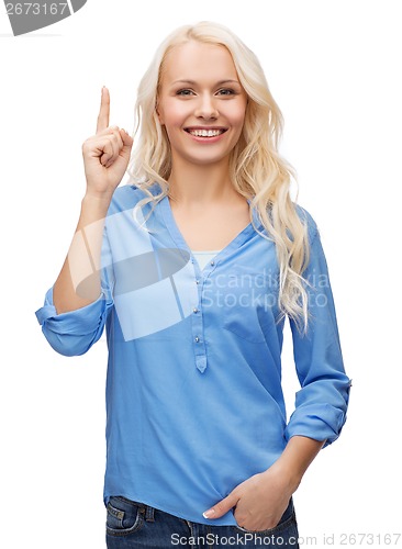 Image of attractive young woman pointing her finger up