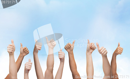 Image of human hands showing thumbs up