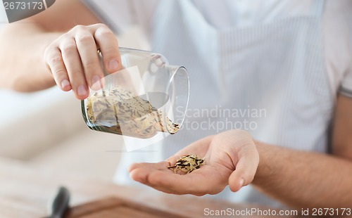 Image of male emptying jar with white and wild black rice