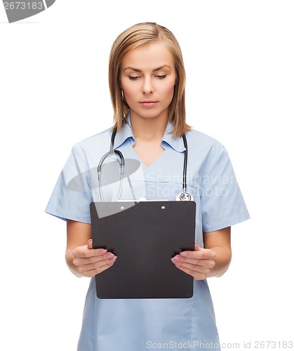 Image of smiling female doctor or nurse with clipboard