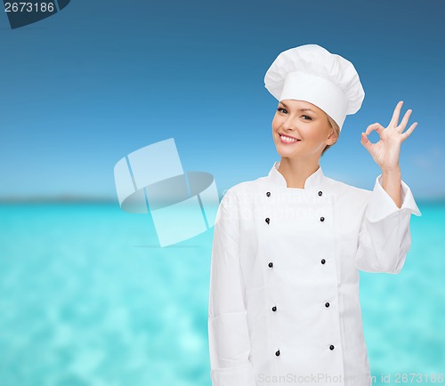 Image of smiling female chef showing ok hand sign