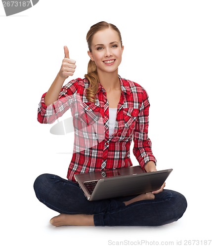 Image of young girl sitting on the floor with laptop