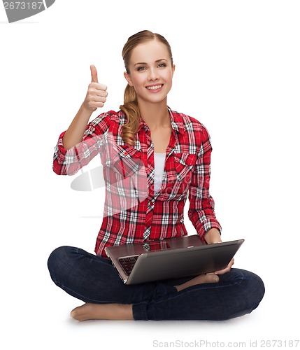 Image of young girl sitting on the floor with laptop