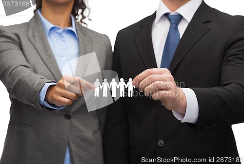 Image of businessman and businesswoman holding paper team
