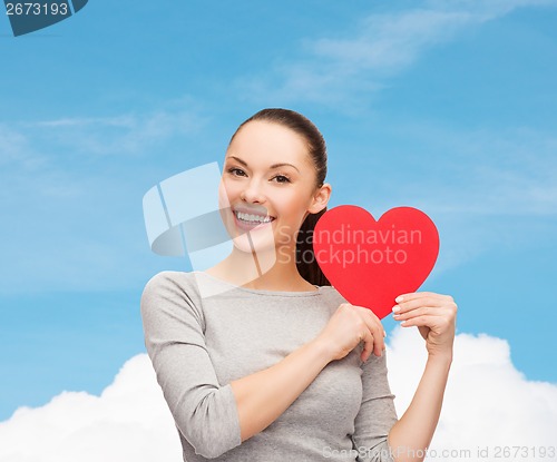 Image of smiling asian woman with red heart