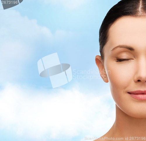 Image of young calm woman with closed eyes