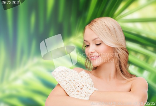 Image of smiling woman with exfoliation glove