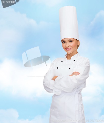 Image of smiling female chef with crossed arms