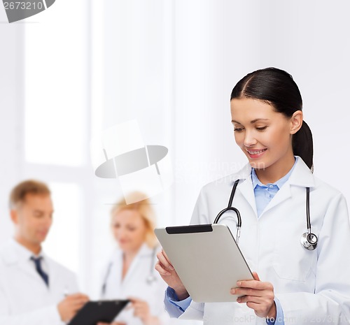 Image of female doctor with stethoscope and tablet pc