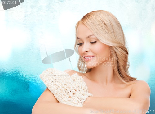 Image of smiling woman with exfoliation glove