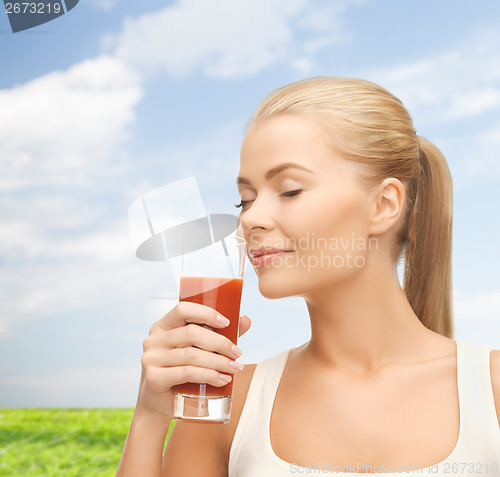 Image of young woman drinking tomato juice