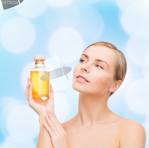 Image of lovely woman with oil bottle