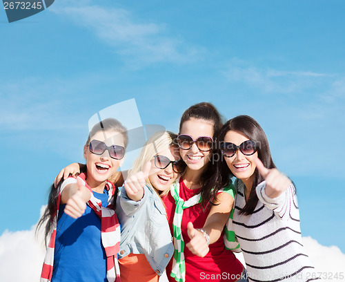 Image of teenage girls or young women showing thumbs up