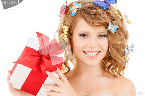 Image of teenager with butterflies in hair showing present