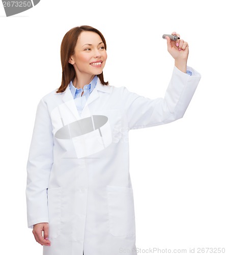 Image of young female doctor writing something in the air