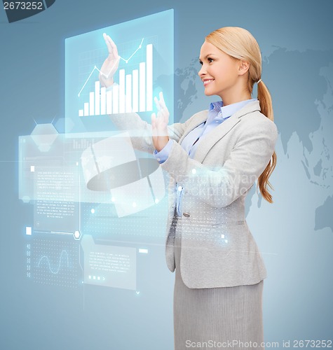 Image of smiling businesswoman working with virtual screen