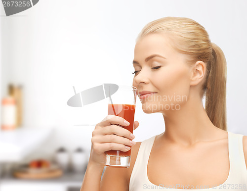 Image of young woman drinking tomato juice