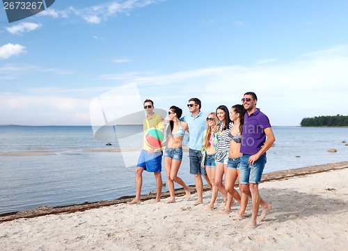 Image of group of friends having fun on the beach