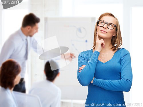 Image of happy woman in black eyeglasses dreaming