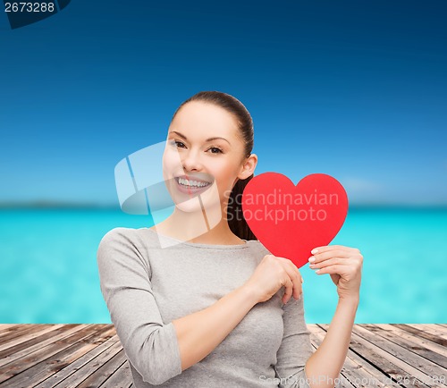 Image of smiling asian woman with red heart