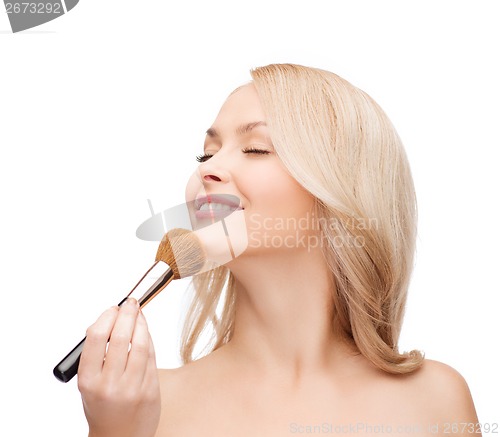 Image of beautiful woman with closed eyes and makeup brush