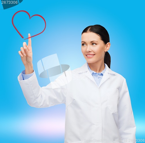 Image of smiling female doctor pointing to heart