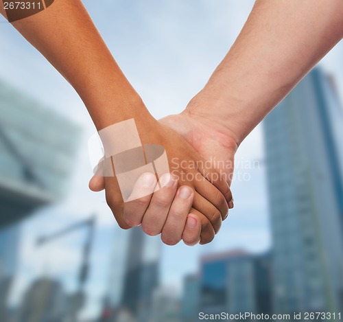 Image of woman and man holding hands