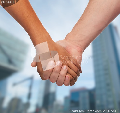 Image of woman and man holding hands