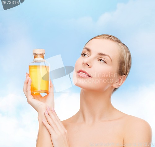 Image of lovely woman with oil bottle
