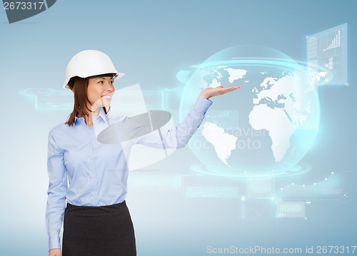 Image of young smiling businesswoman in white helmet