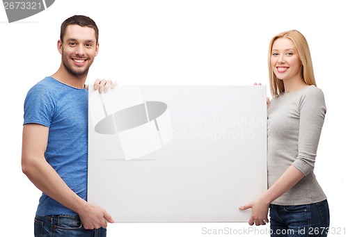 Image of smiling couple holding white blank board