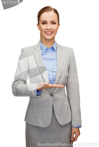 Image of smiling businesswoman holding something imaginary