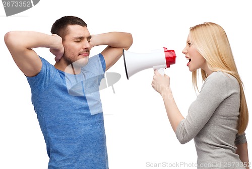 Image of girlfriend screaming though megaphone at boyfriend