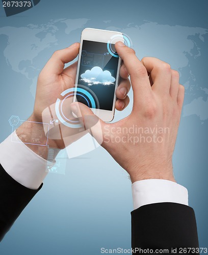 Image of businessman touching screen of smartphone