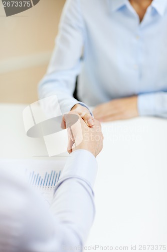 Image of businesswoman and businessman shaking hands