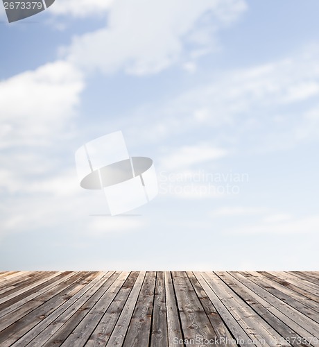 Image of wooden floor and blue sky