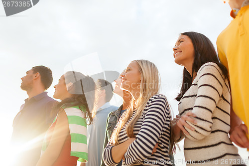 Image of group of friends having fun on the beach