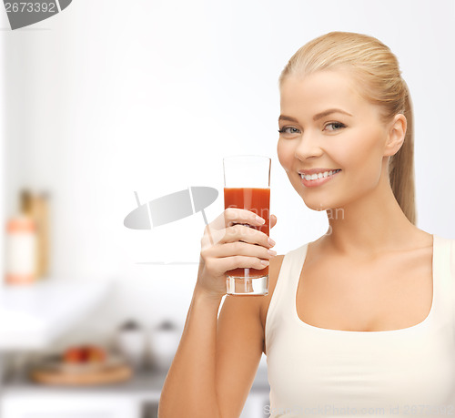 Image of woman holding glass of tomato juice