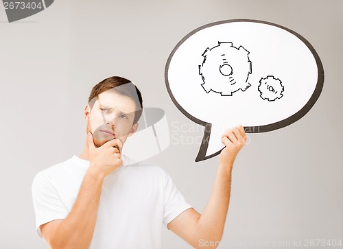 Image of young man with cogwheel in text bubble