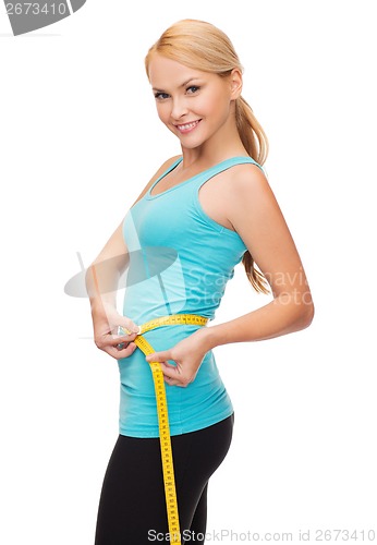 Image of sporty woman with measuring tape