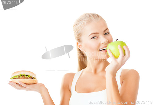 Image of smiling woman with apple and hamburger