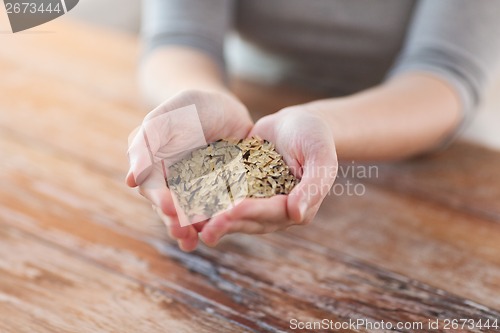 Image of female with white and wild black rice on palm