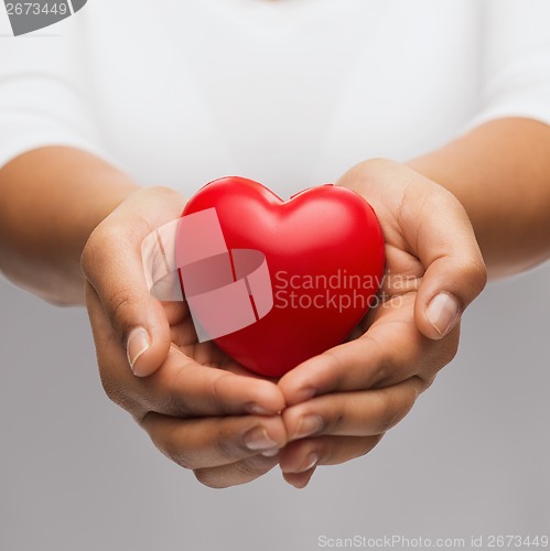 Image of womans cupped hands showing red heart